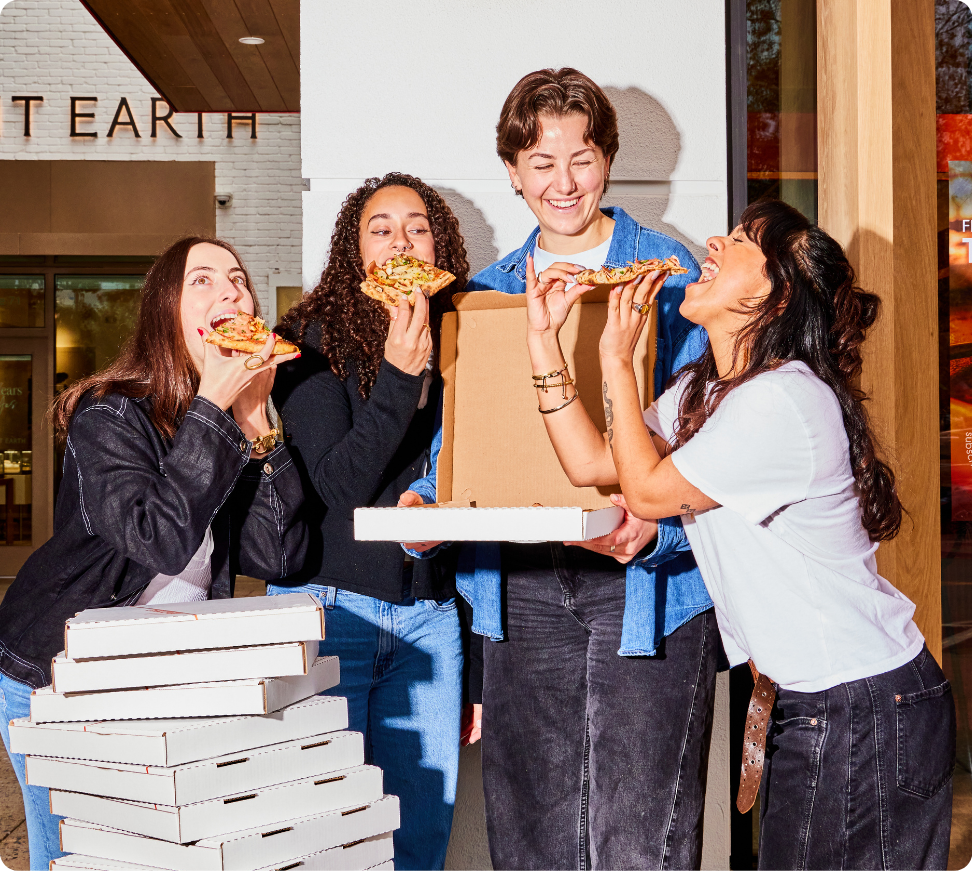 Friends enjoying pizza together at Delarosa