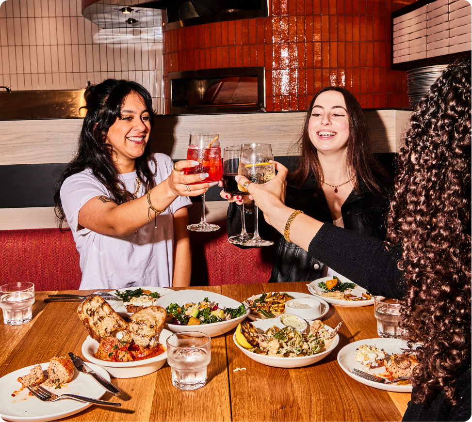 Friends celebrating over dinner at Delarosa